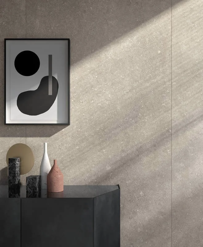 A wall covered in Kronos Ceramiche's Le Reverse Italian porcelain stoneware, available in Elegance or Antique finishes, capturing the natural beauty of stone, available through PietraCasa.