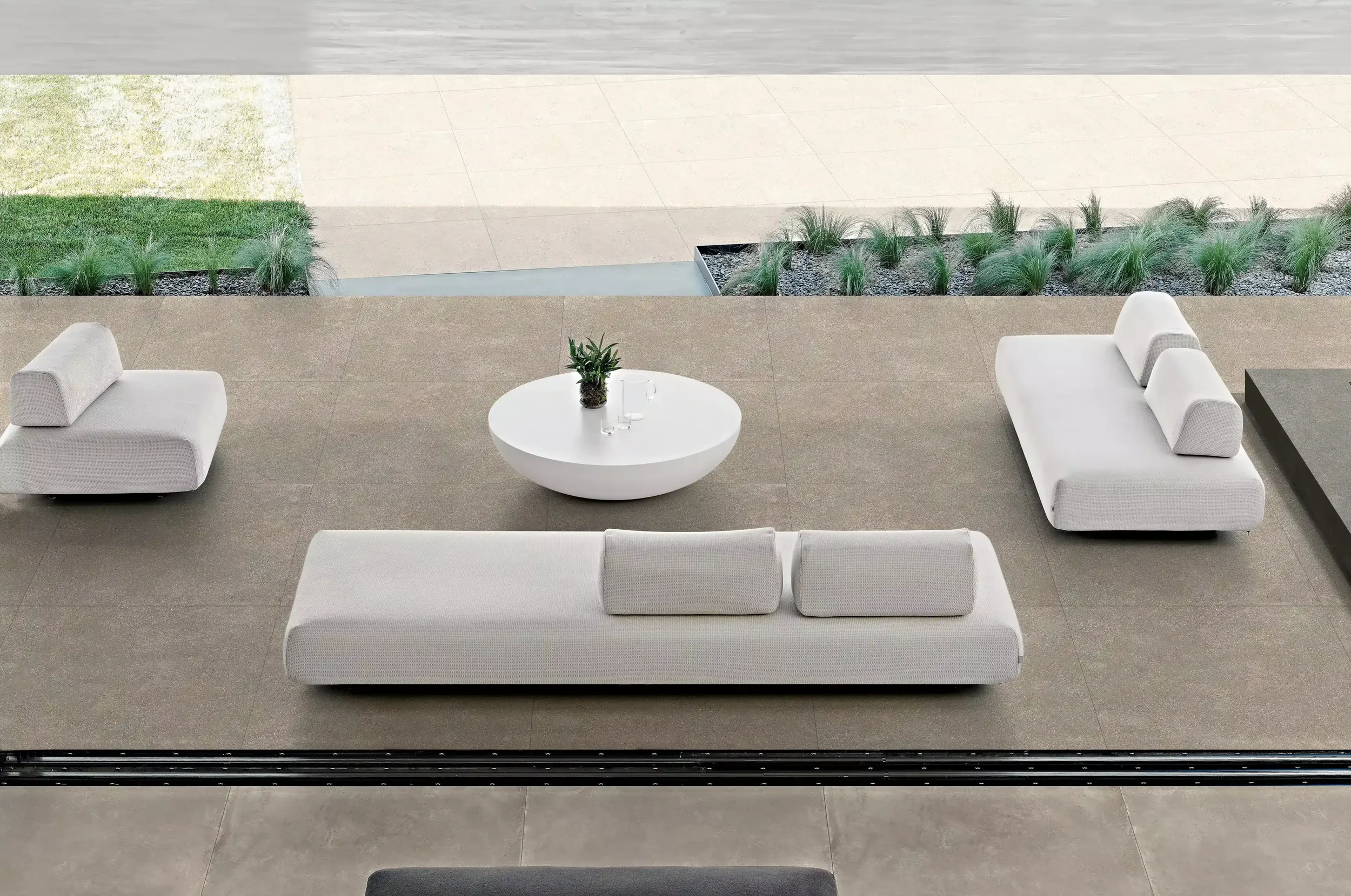 Modern outdoor lounge area featuring the premium Florim Formatech Cast 03 porcelain stoneware tiles, expertly supplied and installed by PietraCasa.