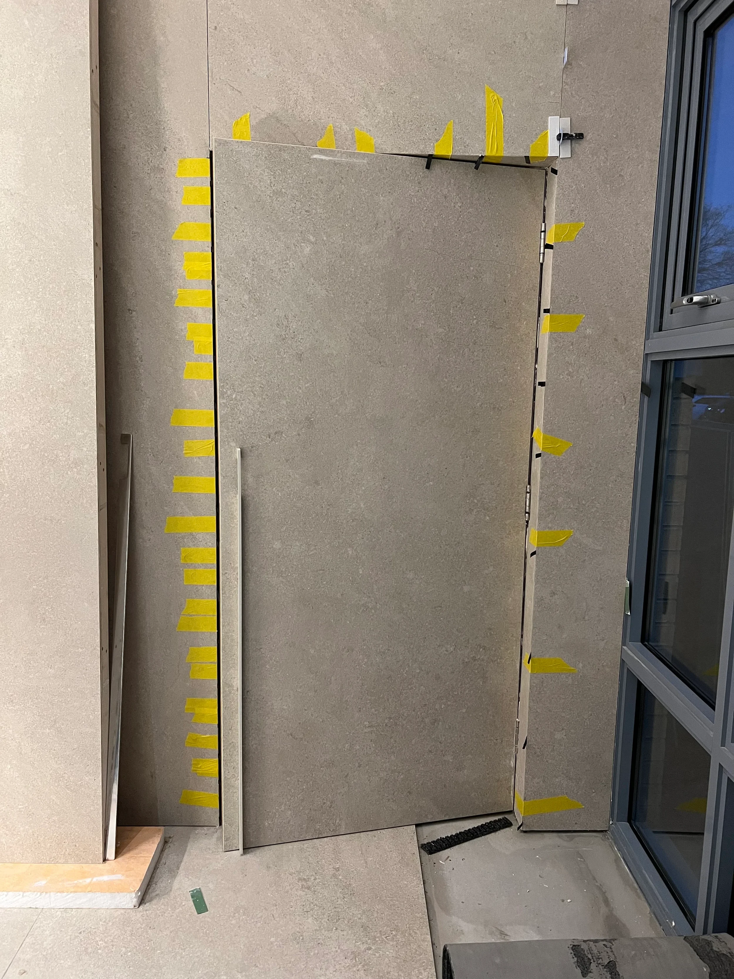 Custom porcelain-cladded hidden door under construction.