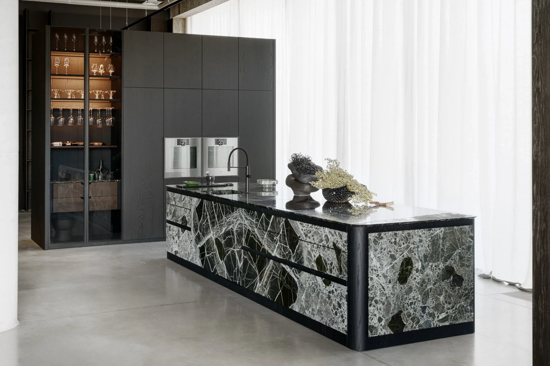 Luxurious kitchen island from the Zajc FOREST collection, featuring Breccia Imperiale marble supplied and finished by Margraf.