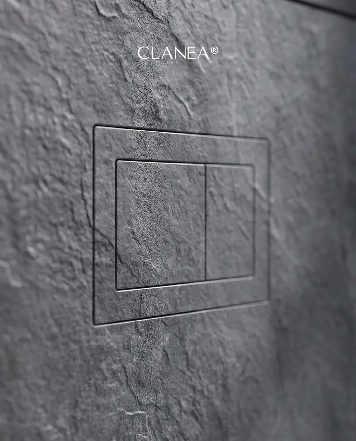 Close-up detail of a flush-mounted Clanea PurePlate toilet flush cover, expertly integrated into a natural stone wall for a seamless look, supplied and installed by PietraCasa.