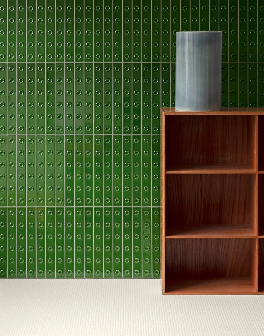 Green Mutina Punto ceramic wall tile installation featuring a distinct three-dimensional surface with either elevated or sunken dots, designed by Ronan & Erwan Bouroullec, available through PietraCasa.