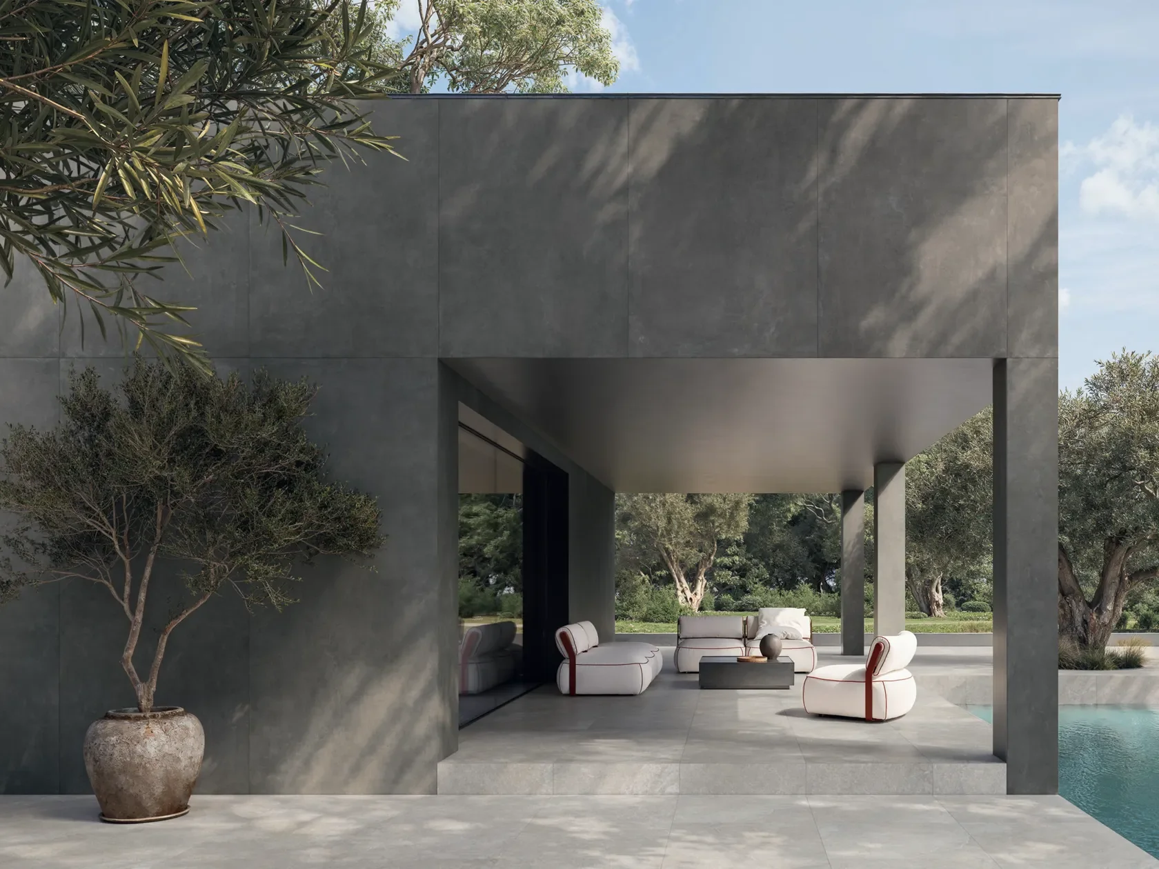 Sophisticated outdoor living space featuring the premium Concrete collection by Impronta Ceramiche, Italgraniti Group, highlighting seamless integration and durable porcelain stoneware, supplied by PietraCasa.