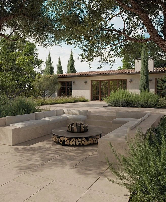 An outdoor Mediterranean patio setting showcasing the Ske 2.0 outdoor collection by Italian porcelain stoneware manufacturer Kronos Ceramiche, available through PietraCasa
