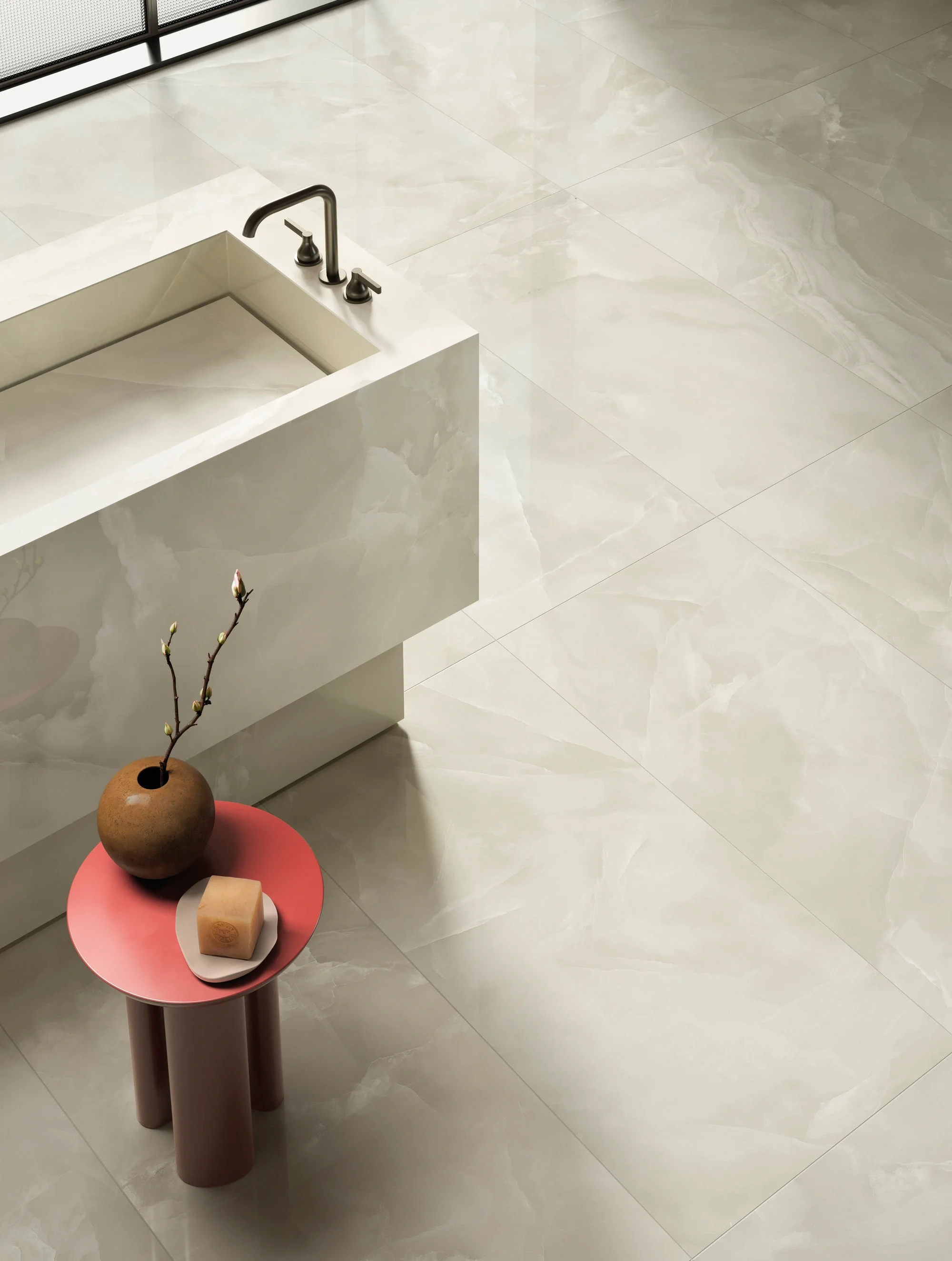 Sophisticated bathroom design featuring Onice Ghiaccio porcelain tiles by Iris FMG, mimicking the translucent, polished look of natural onyx, paired with a custom tile-clad vanity and installed by PietraCasa.