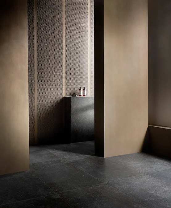 A serene, minimalist setup featuring the Evolution collection by Kronos Ceramiche, a series of porcelain stoneware tiles inspired by Nordic natural stone, available through PietraCasa.