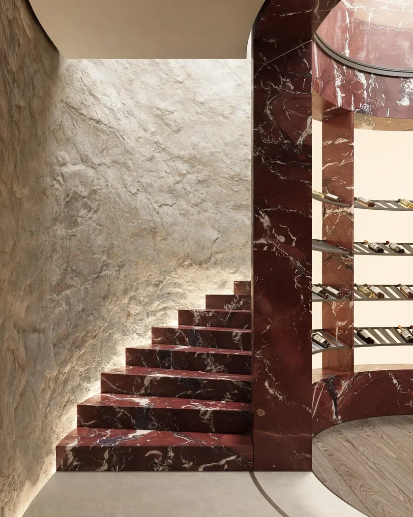 Sophisticated interior featuring Rosso Cardinale marble by Margraf, showcasing a bespoke staircase and wine storage area, supplied by PietraCasa.