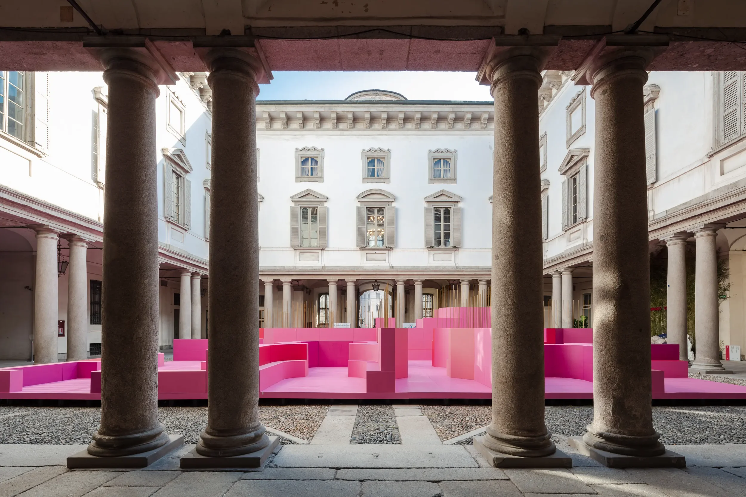 Wide view of Lina Ghotmeh's "Metamorphosis in Motion" at Milan Design Week 2026, featuring a perfectly level platform created by PietraCasa using Eterno Ivica adjustable pedestals over uneven historic pavers.