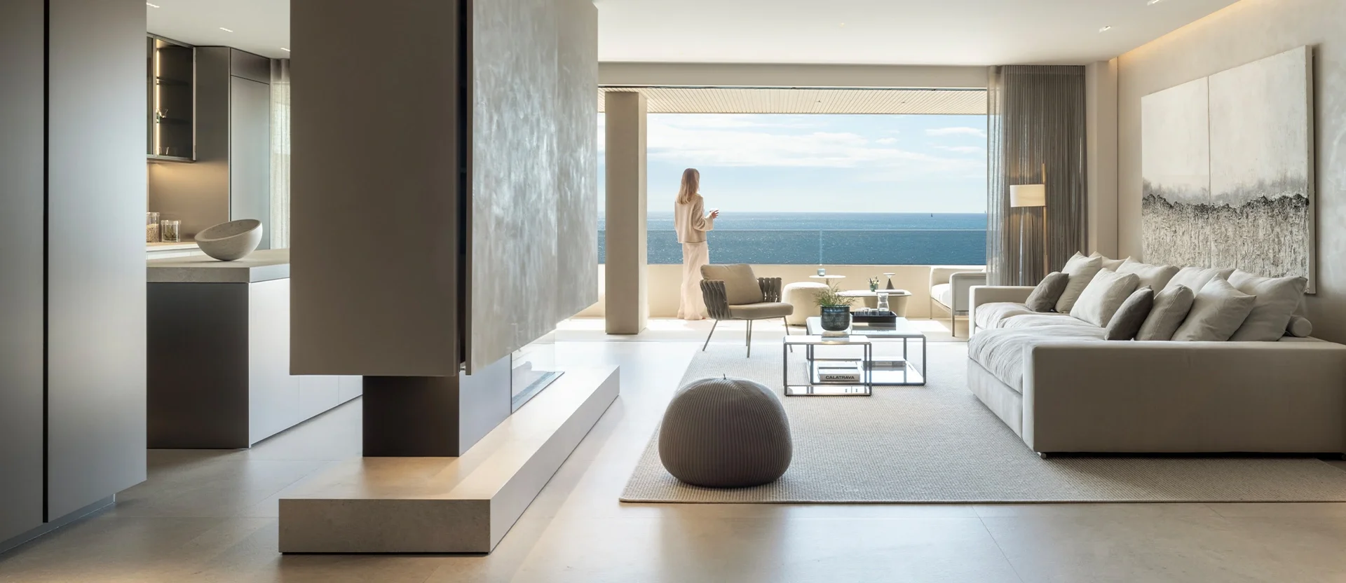 Luxurious living room featuring premium Inalco Petra MDi surfaces, creating seamless, natural stone textures from the floating fireplace divider to the cohesive flooring, exclusively distributed in the UK by PietraCasa.