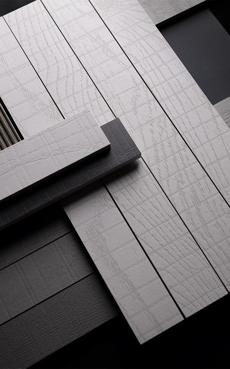 A close-up view of Living Ceramics Rem porcelain stoneware tiles, which combine a wood grain base with a textured, criss-cross grid of parallel lines, available through PietraCasa.