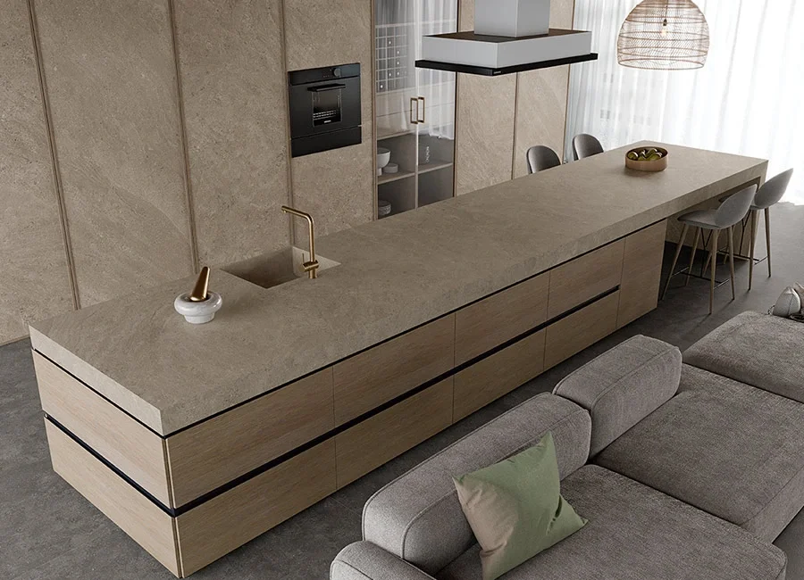 Sleek kitchen featuring the Inalco Petra Crema MDi collection as a continuous porcelain surface on the island, walls, and cabinetry, exclusively distributed in the UK by PietraCasa
