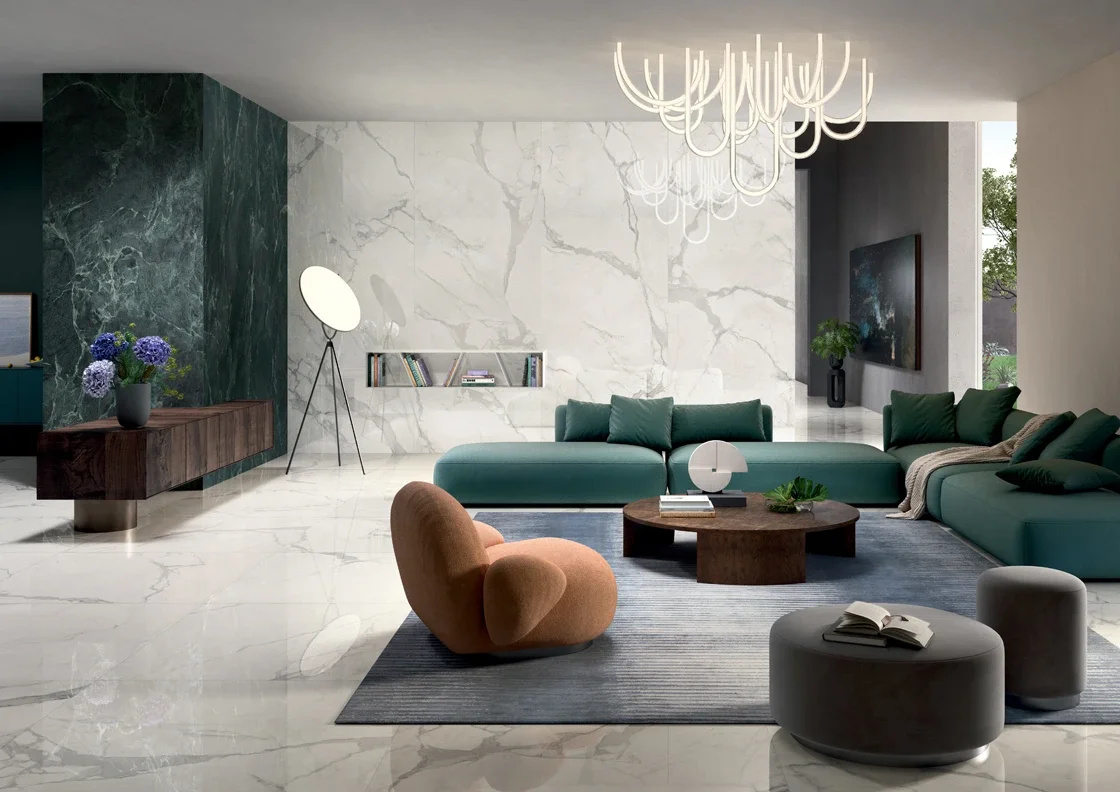 An elegant living room featuring Statuario Supreme marble-effect porcelain slabs from the Lea Ceramiche Noblesse collection, showcasing large polished surfaces and realistic veining, available through PietraCasa.