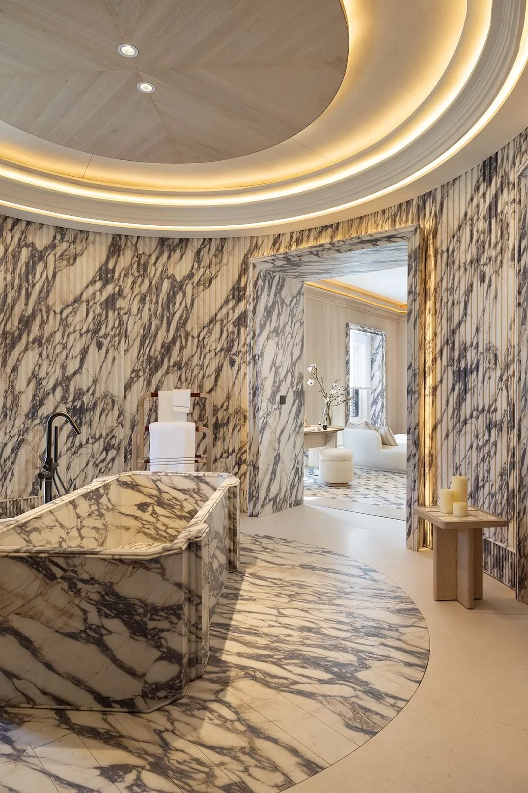 Luxurious circular 'Dress Code' suite designed by Jaime Beriestain Studio for Casa Decor, featuring SapienStone Fior Di Viola 4D porcelain in Rilievo Cresta texture, supplied by PietraCasa.