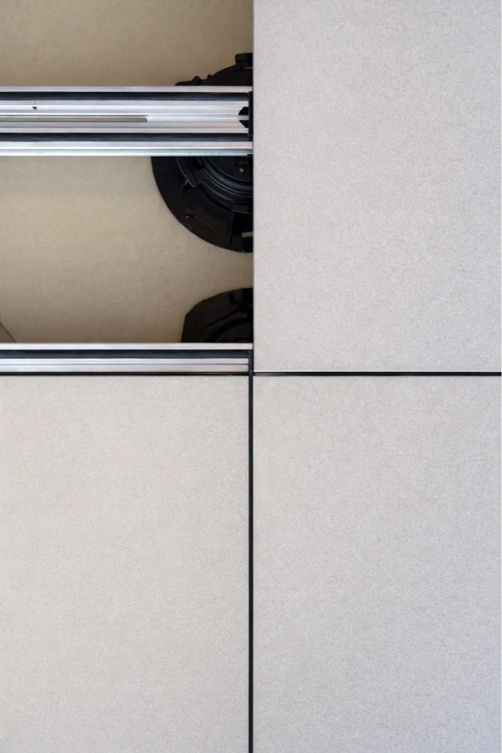 Installation of outdoor porcelain tiles on an adjustable pedestal rail system.