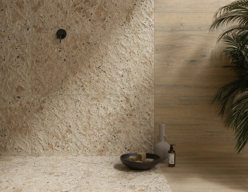 Textured interior wall and floor featuring Ariostea Fragmenta Arlecchino porcelain tiles, designed to resemble vibrant, polychromatic stone fragments, supplied and installed nationwide by PietraCasa.