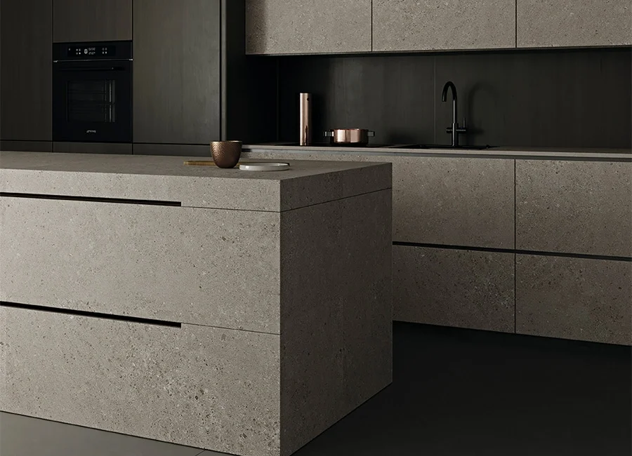 Modern kitchen with island and cabinetry clad in Inalco Masai MDi surfaces, creating a monolithic aesthetic with a fine, pebble-like stone finish, exclusively distributed in the UK by PietraCasa.