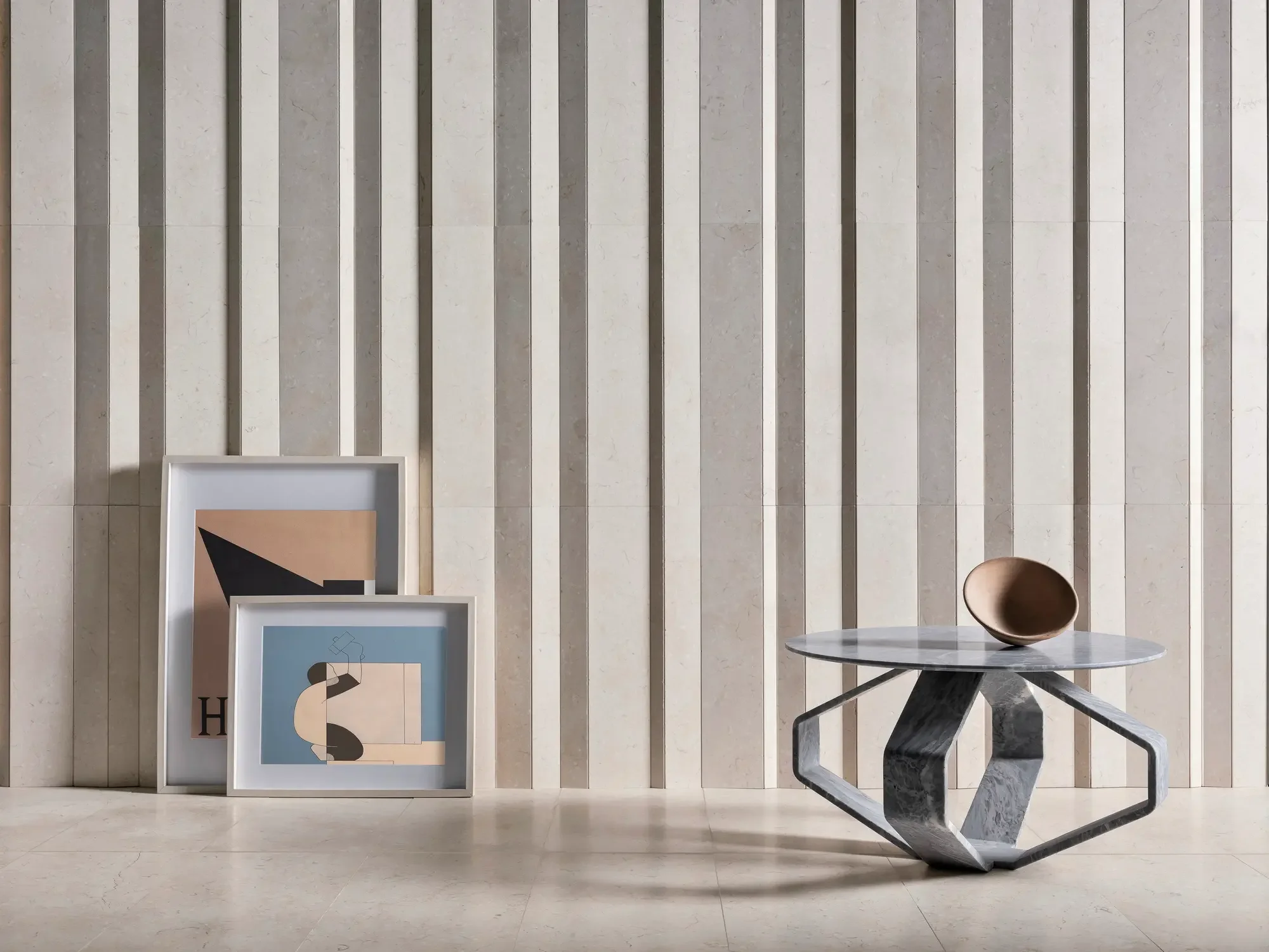 The Filone Round Grey Marble Coffee Table by Italian luxury brand Luce di Carrara, featuring a distinctive sculptural base and polished stone top, available through PietraCasa.