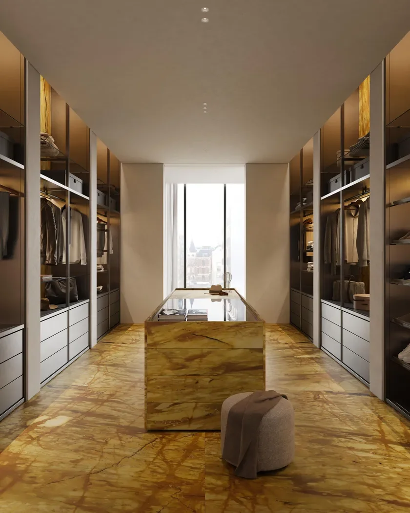 Luxurious walk-in wardrobe featuring an island and flooring in Giallo Siena natural marble by Margraf, supplied by PietraCasa.