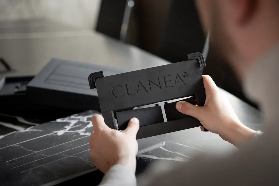 Close-up detail of the Clanea® PurePlate, a professional Swiss-made toilet flush plate component designed for invisible, flush-mounted installation, supplied and installed by PietraCasa.