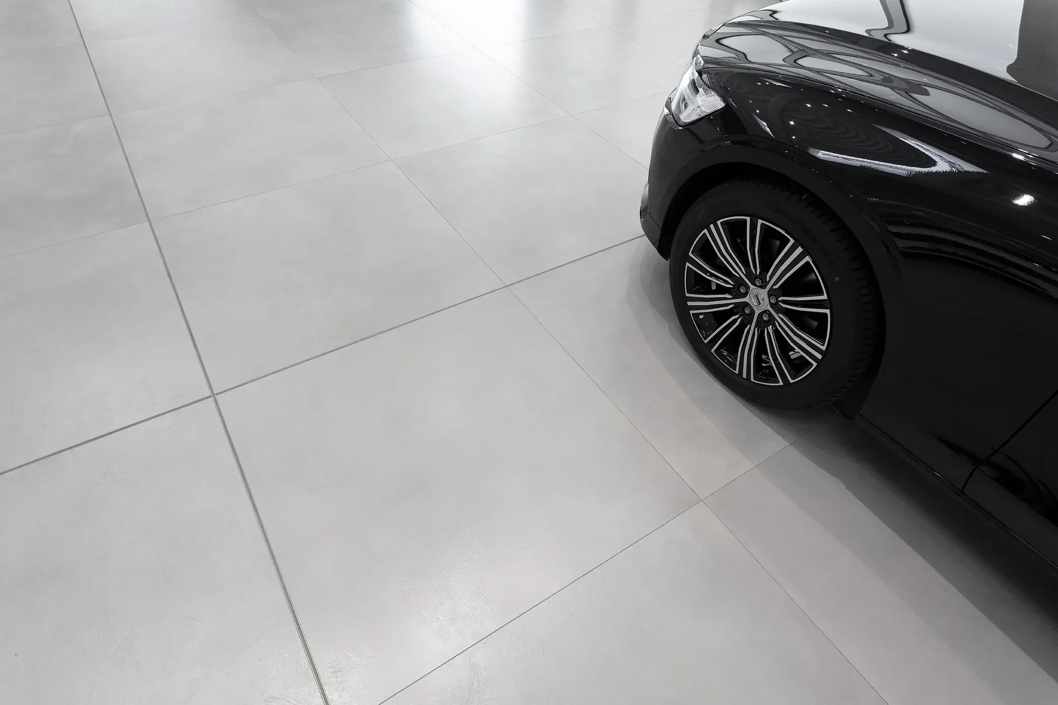 Luxury automotive showroom featuring high-performance Fiandre large format flooring slabs.