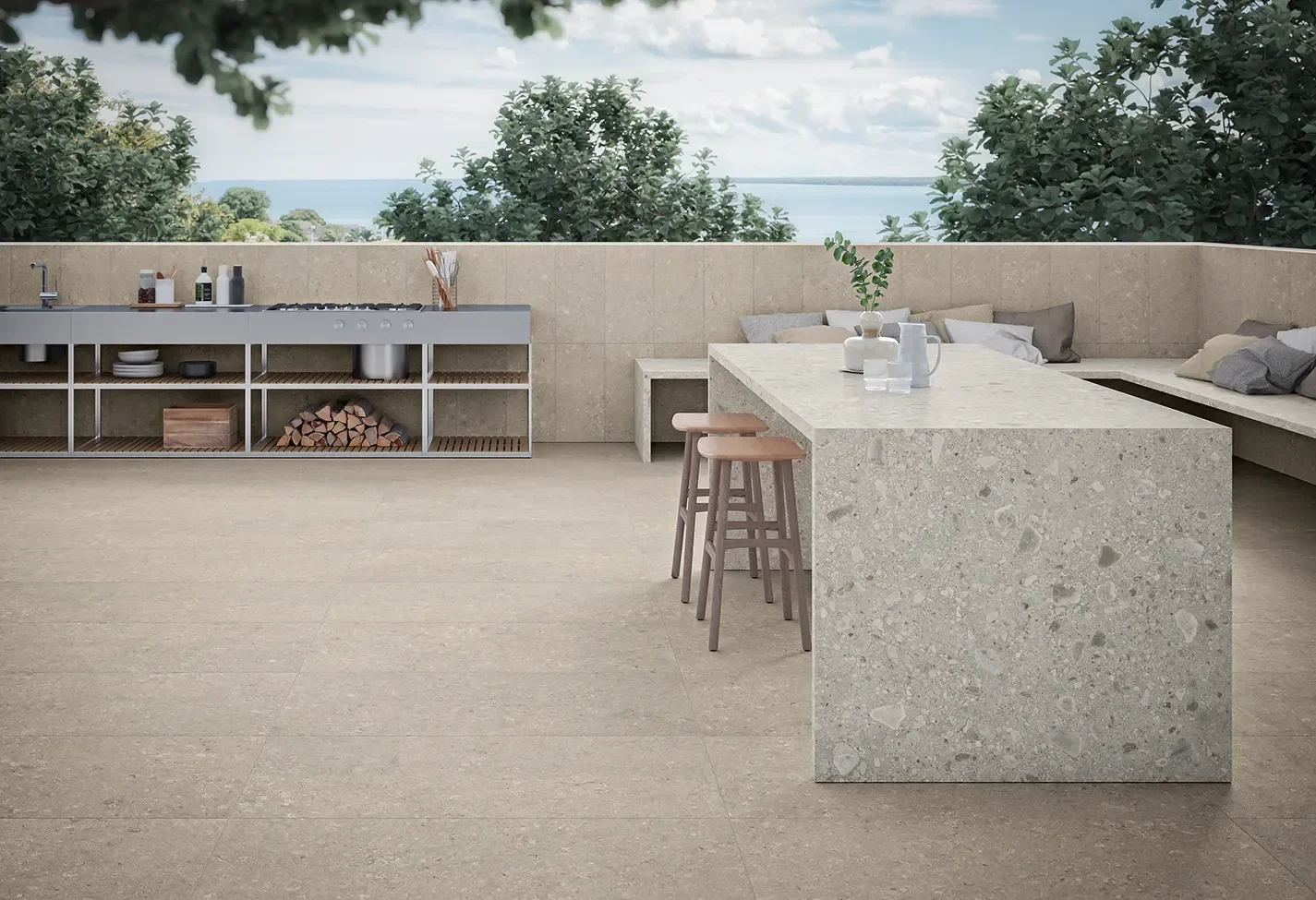 Modern outdoor living space featuring Ceramiche Keope Heritage porcelain stone-effect tiles, a kitchen island with a terrazzo-style top, and an outdoor kitchen setup, available through PietraCasa.