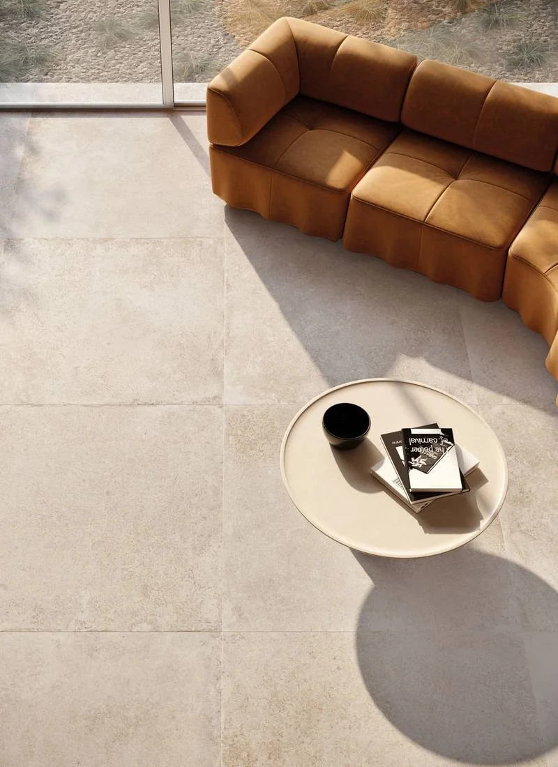 Modern interior space featuring the INX porcelain tile collection by Supergres, offering a versatile, contemporary concrete effect, supplied by PietraCasa.