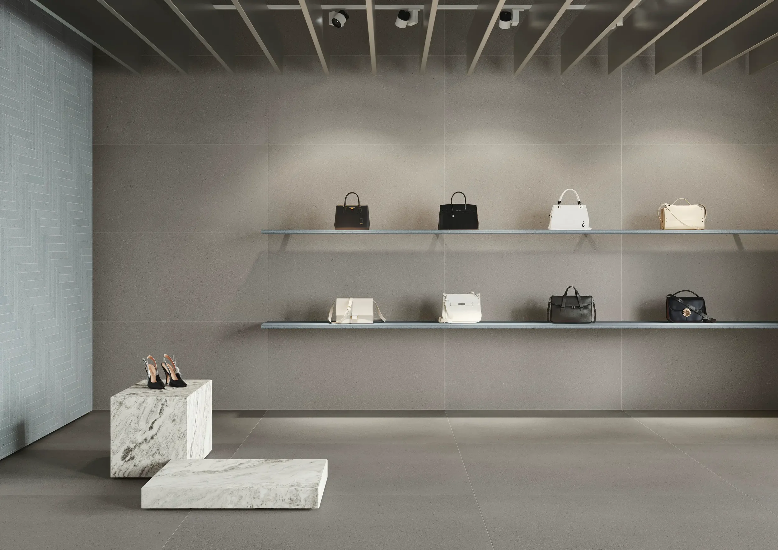 Minimalist retail display featuring FMG TerraPura Pura Grigio porcelain stoneware tiles, engineered for a continuous look across floors and walls, expertly supplied and installed by PietraCasa.
