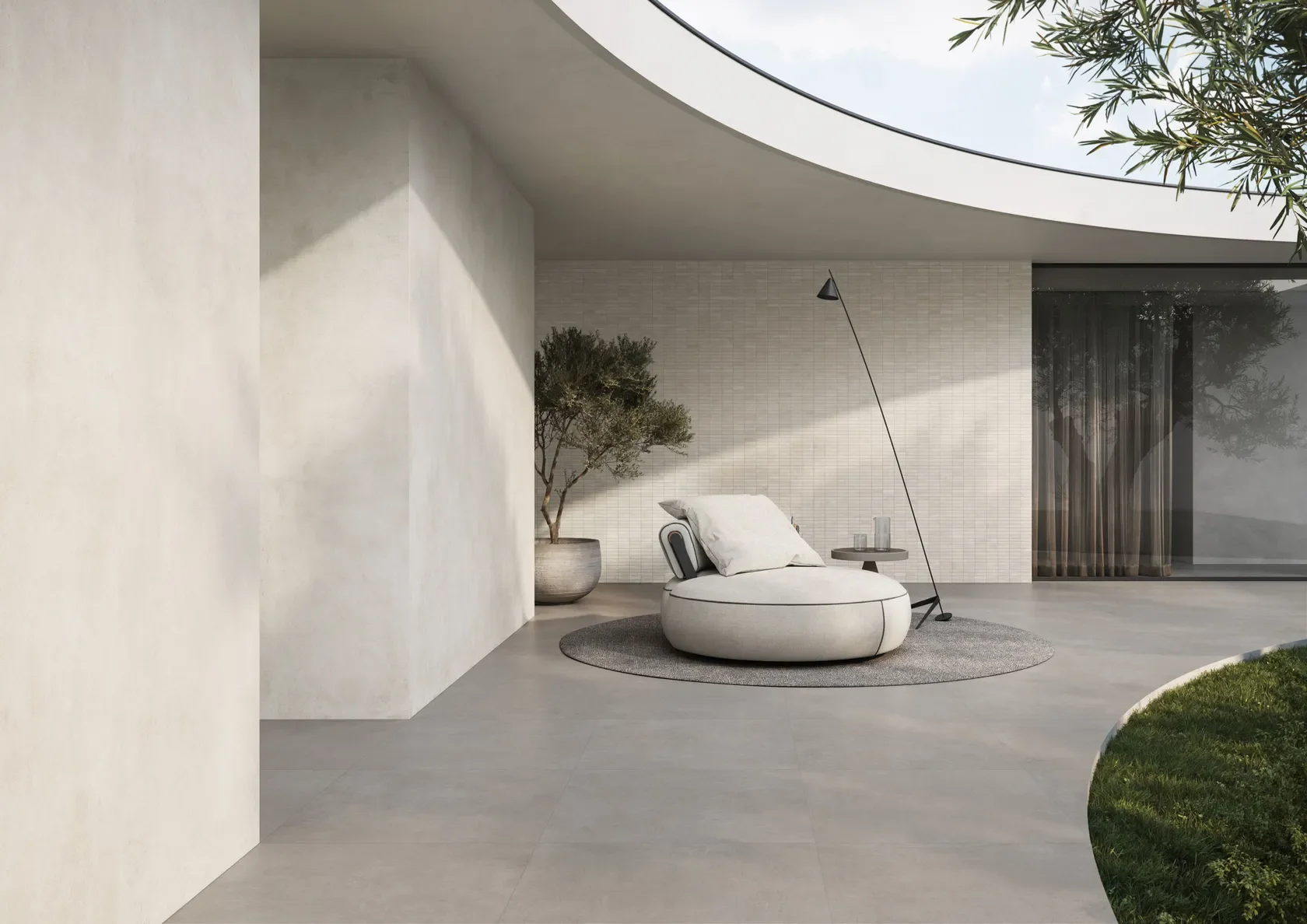 Seamless indoor-outdoor living space featuring premium porcelain stoneware tiles from the Concrete collection by Impronta, showcasing a matte, cement-inspired texture, supplied by PietraCasa.