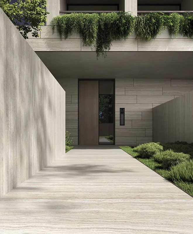 A modern minimalist residential entrance featuring high-end Kronos Ceramiche architectural porcelain stoneware, available through PietraCasa.