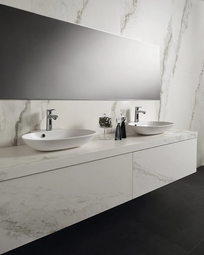 Sleek double bathroom vanity featuring bespoke countertop basins and a monolithic countertop in Inalco’s Petra Crema, an antibacterial, micro-textured mineral surface, exclusively distributed in the UK by PietraCasa.