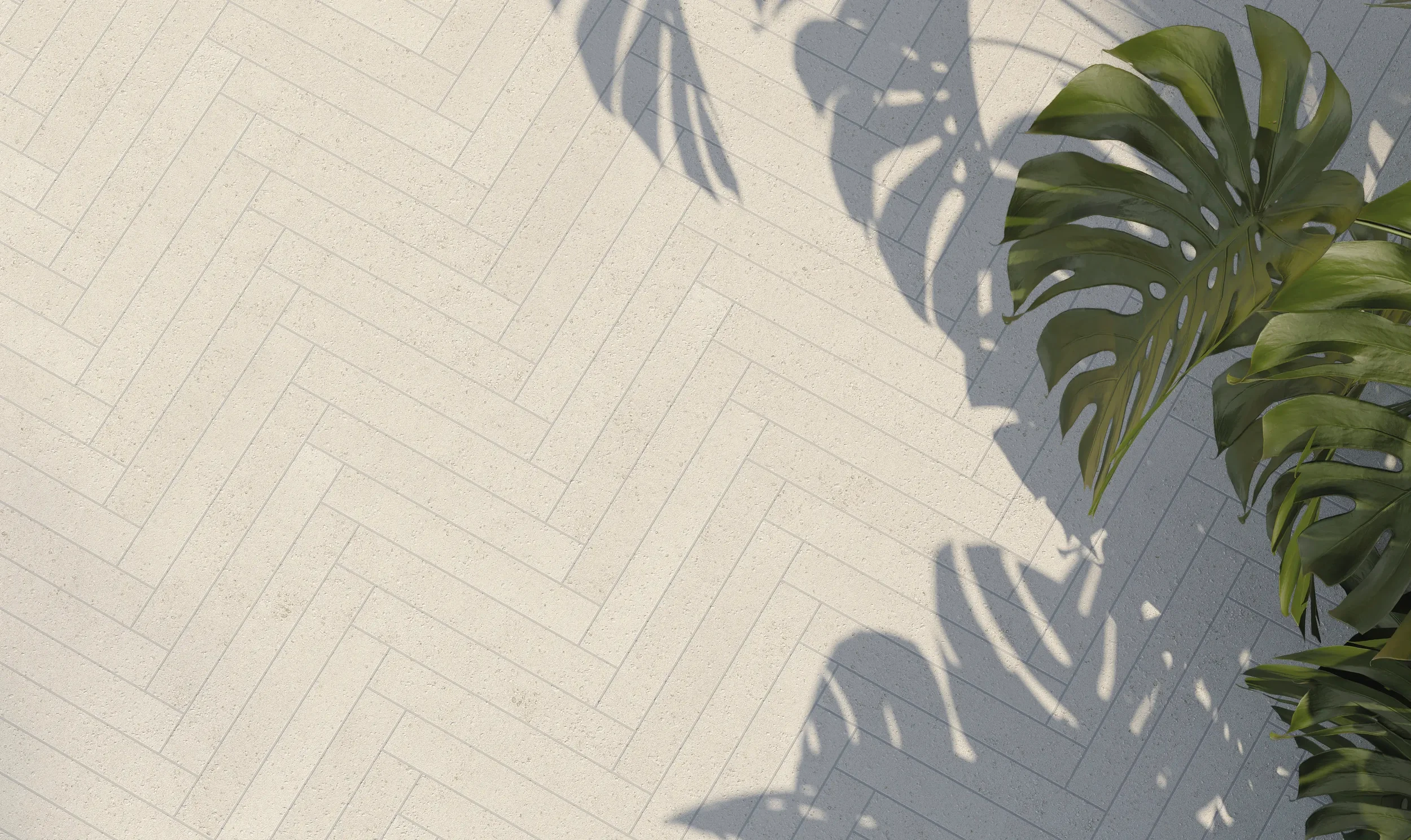 Modern flooring featuring the TerraPura Pura Bianco collection by FMG Fabbrica Marmi e Graniti, installed in a sophisticated herringbone pattern, expertly supplied and installed by PietraCasa.