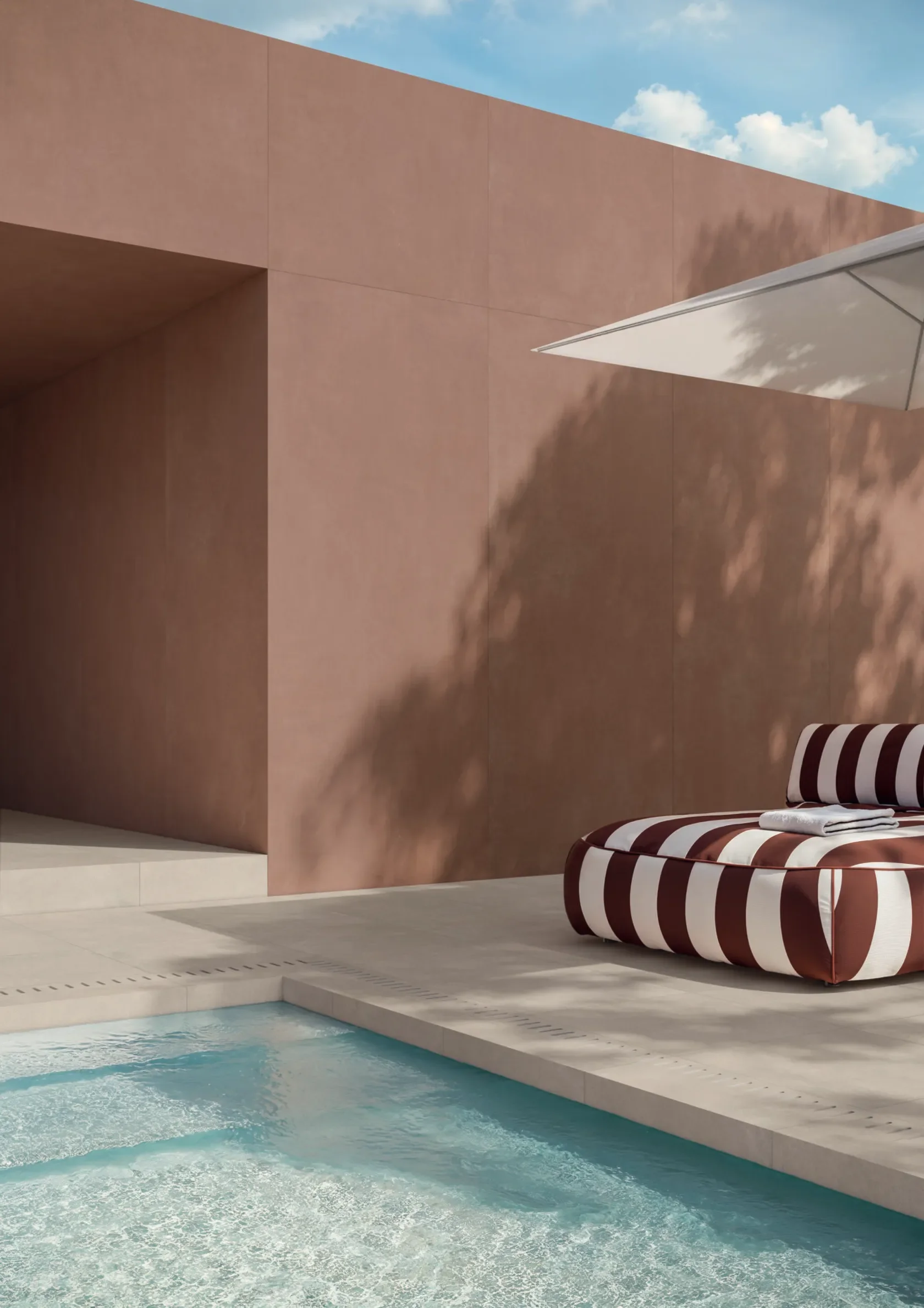 Modern outdoor pool area featuring the durable Concrete collection by Impronta Ceramiche, part of the Italgraniti Group, supplied by PietraCasa.