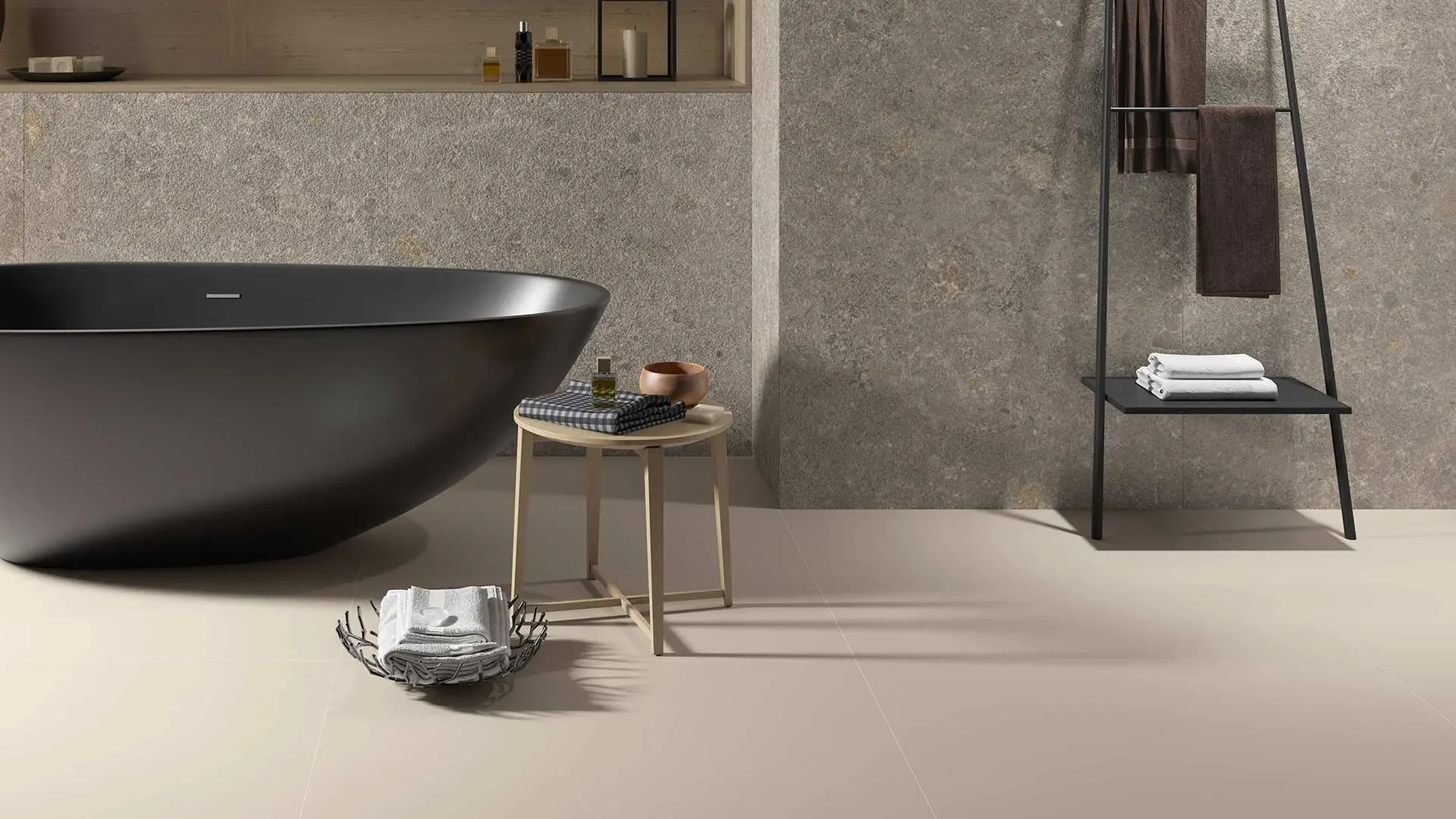 Luxurious bathroom featuring the Inalco Meteora Gris, an award-winning ultra-large format ceramic slab that emulates a rugged, meteorite-like appearance with gold, grey, and red undertones, exclusively distributed in the UK by PietraCasa.