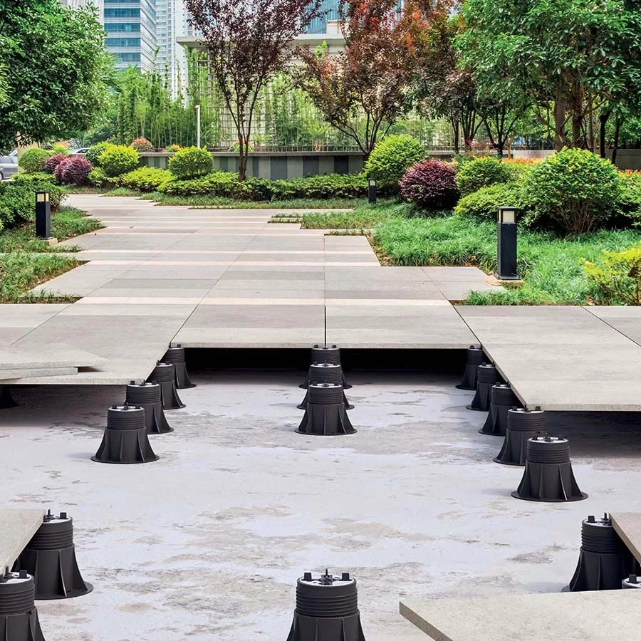 Outdoor paving system utilizing Eterno Ivica pedestal supports to create a stable, level, and raised walkway over uneven ground, supplied and installed by PietraCasa.