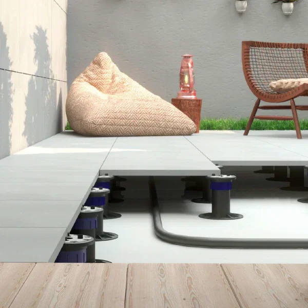 Peygran XSP Pro height-adjustable, self-levelling pedestals supporting outdoor 2cm porcelain pavers to create a floating floor system with hidden drainage and plumbing, supplied by PietraCasa