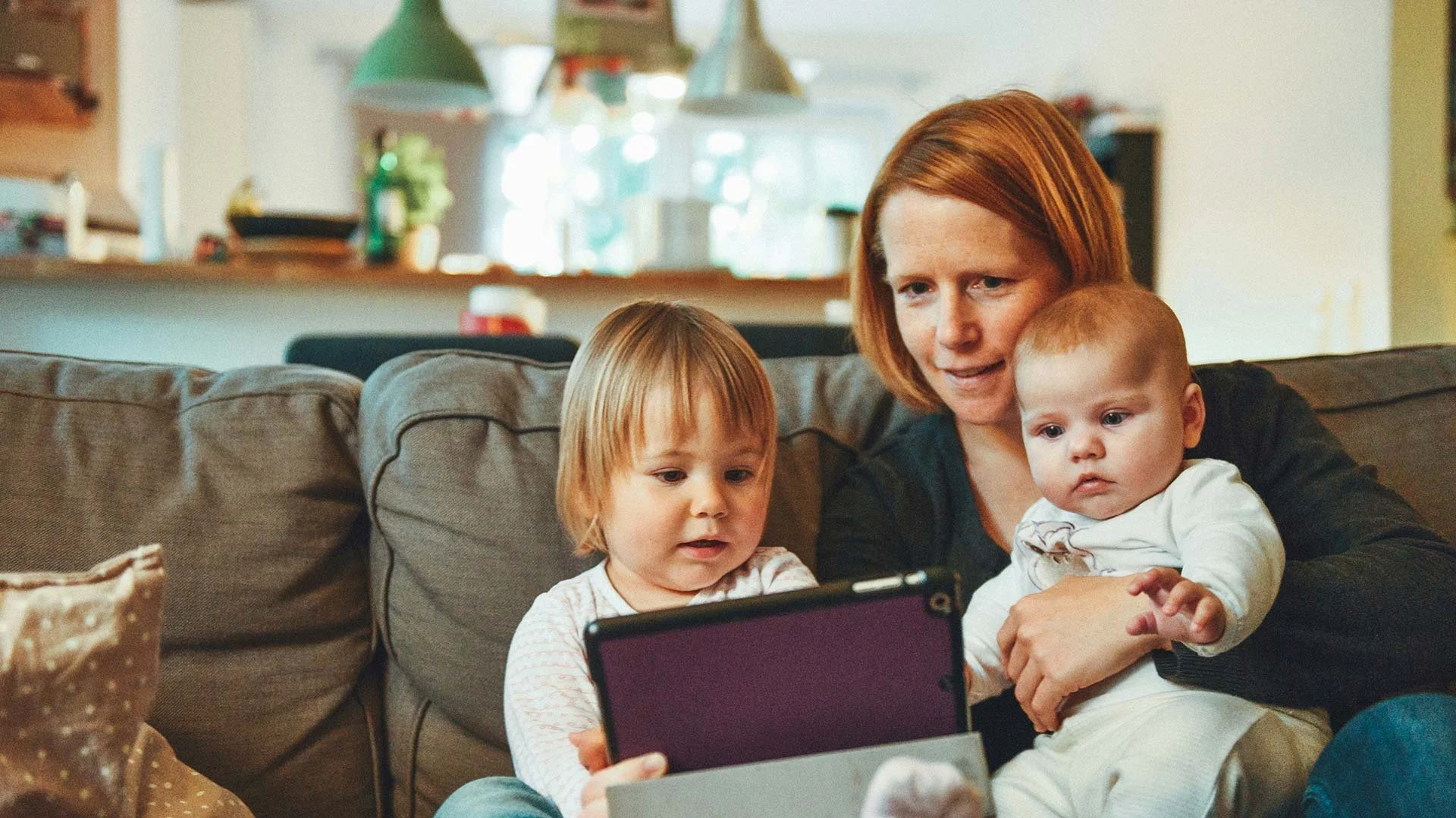 Photo of a Mom with kids on the couch