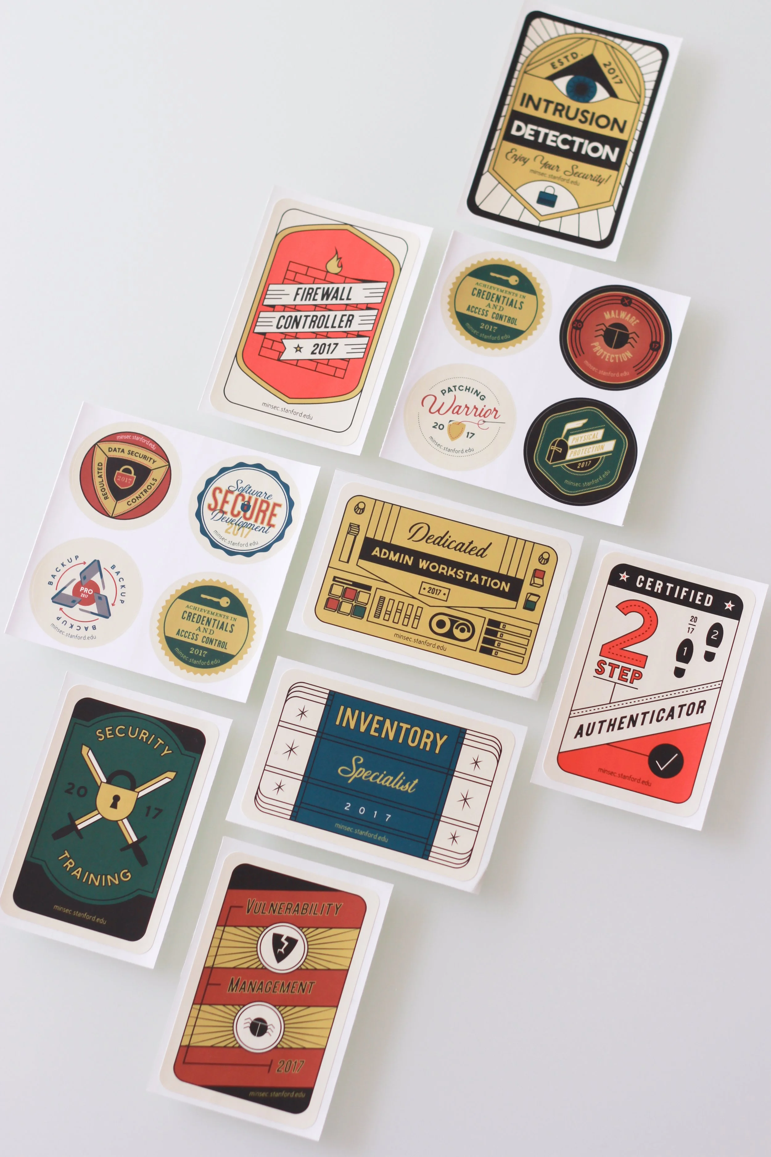 Collection of cybersecurity and security-themed stickers on white background, including labels for intrusion detection, firewall controller, malware protection, secure development, and inventory specialist.