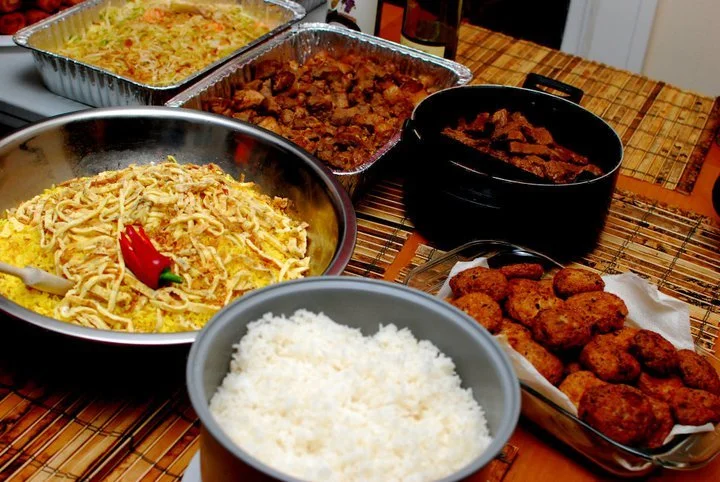 A table filled with island comfort—steamed white rice, slow-braised pork, and Oma’s Dutch-style fritters, all made with heart and meant to be shared.