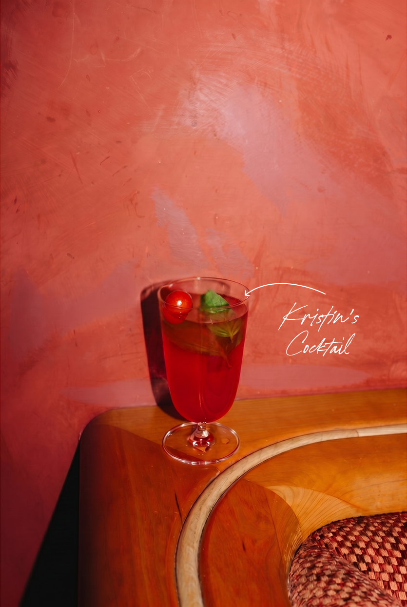 Kristin's cocktail — a tall red drink garnished with cherry and basil