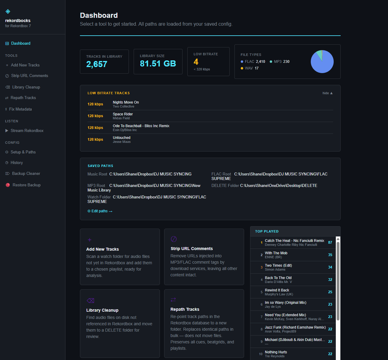 Screenshot of a music library management dashboard showing total tracks, library size, low bitrate tracks, file types, saved paths, and top played songs.