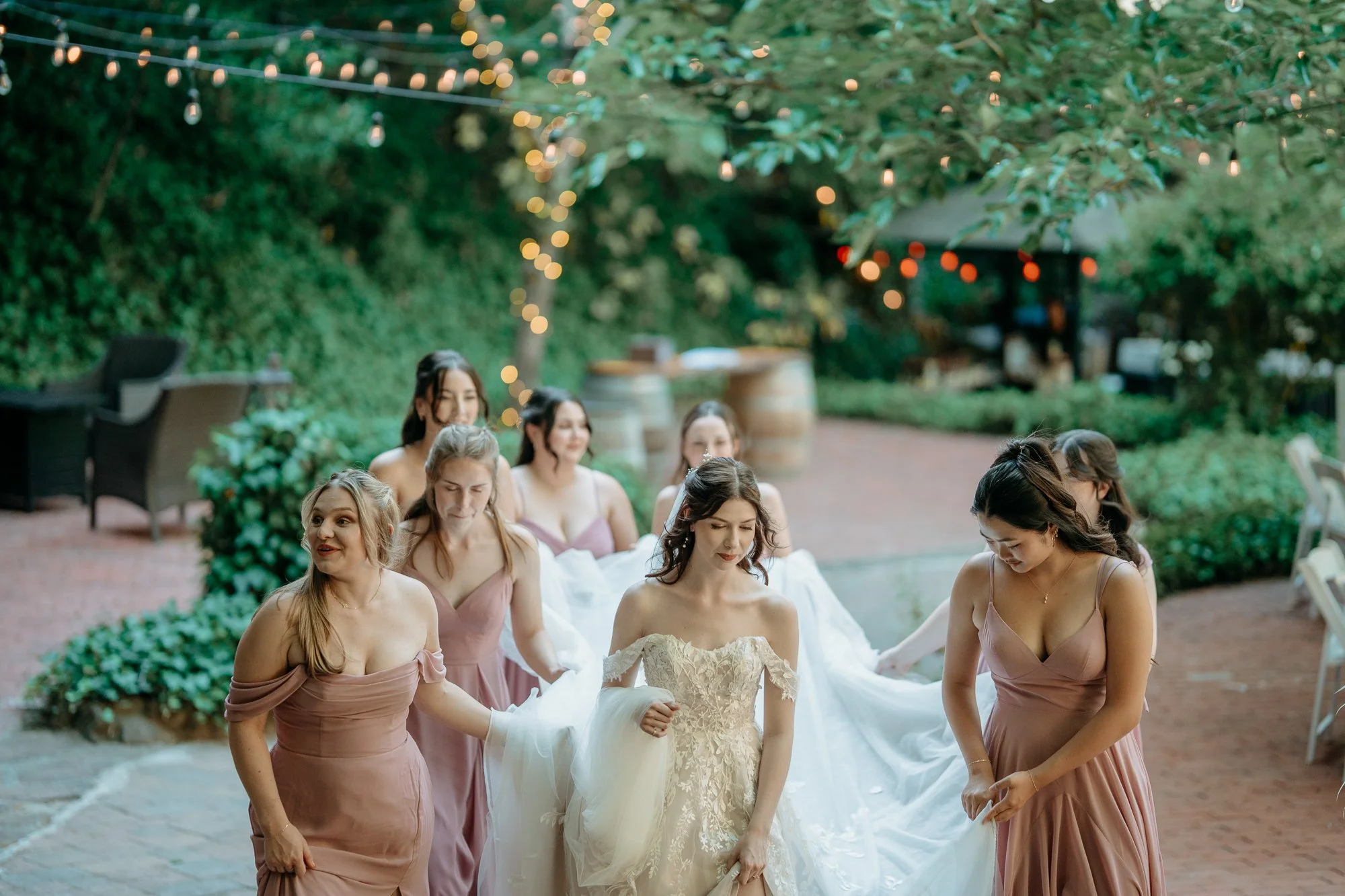 Bride with her bridesmaids on the reception patio at Wildwood Acres