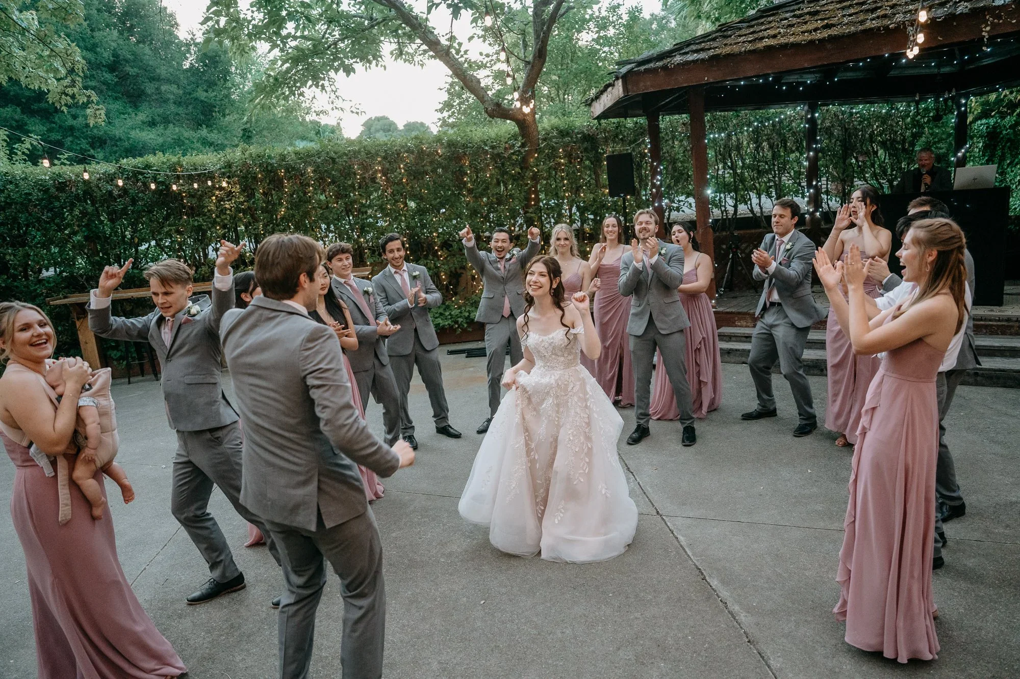 Bride and bridesmaids dancing into the reception