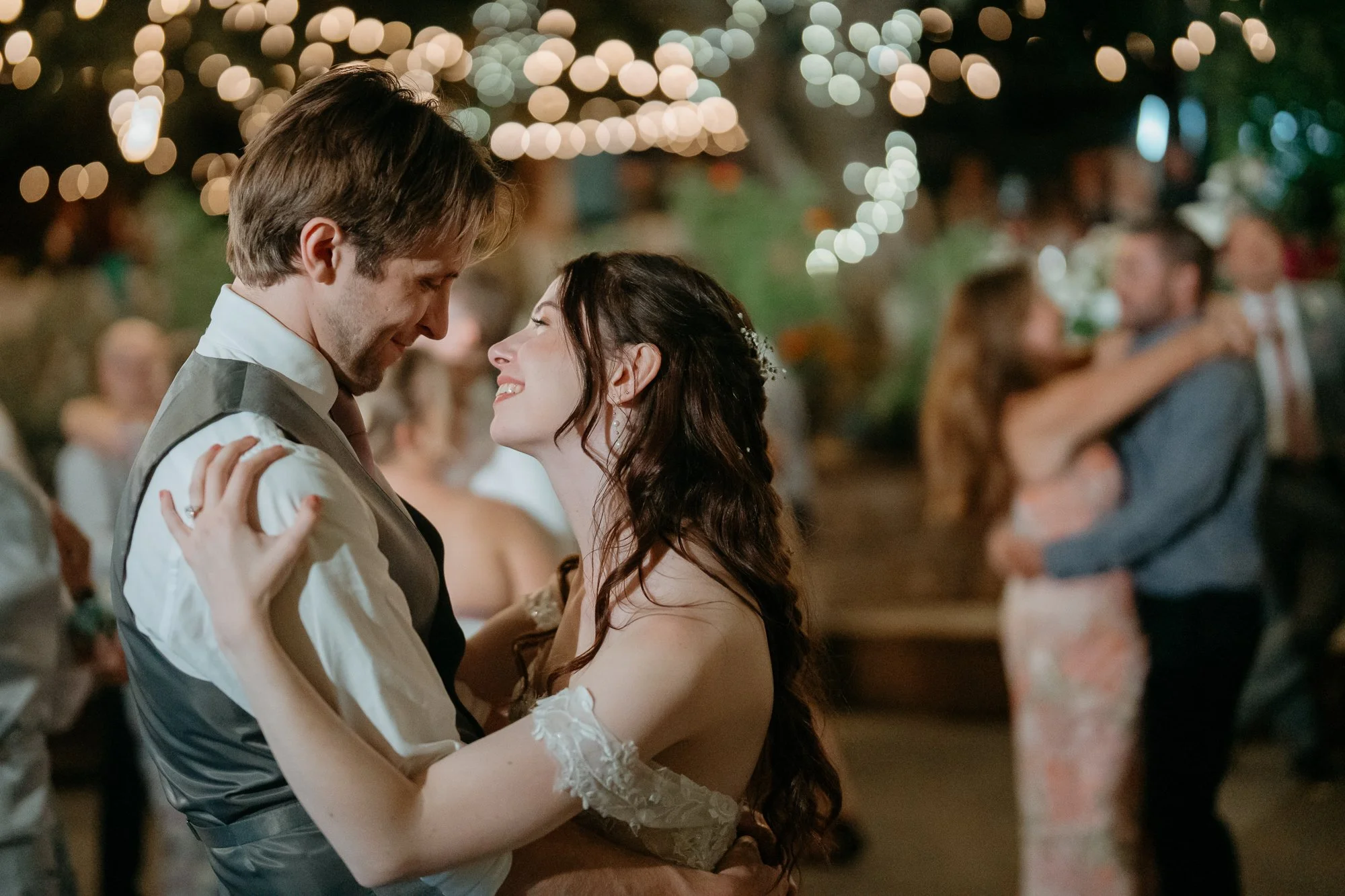 Couple sharing their first dance under the lights