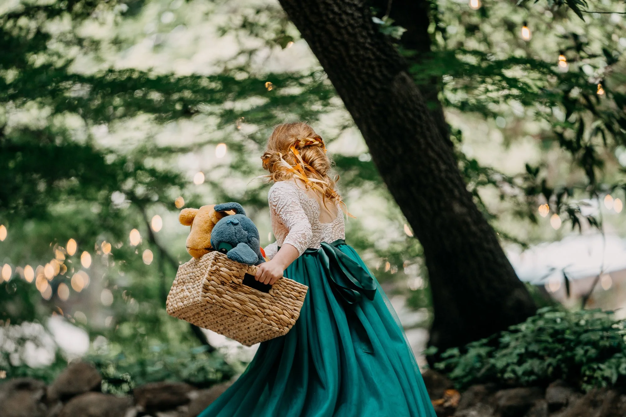Flower girl with her basket among the oak trees