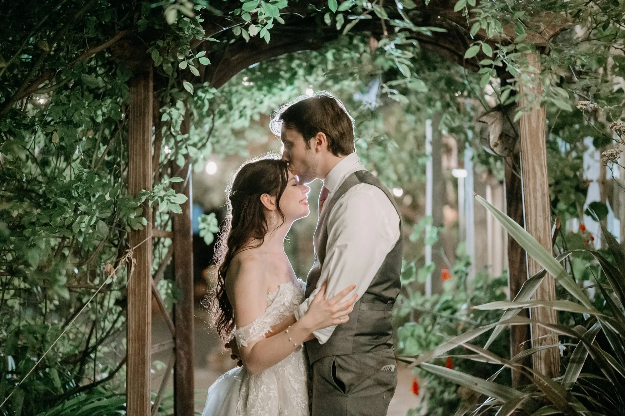 Couple under a leafy arbor