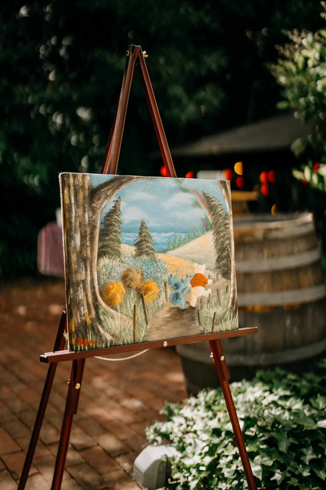 Hand-painted wedding welcome sign on an easel at Wildwood Acres, Lafayette CA