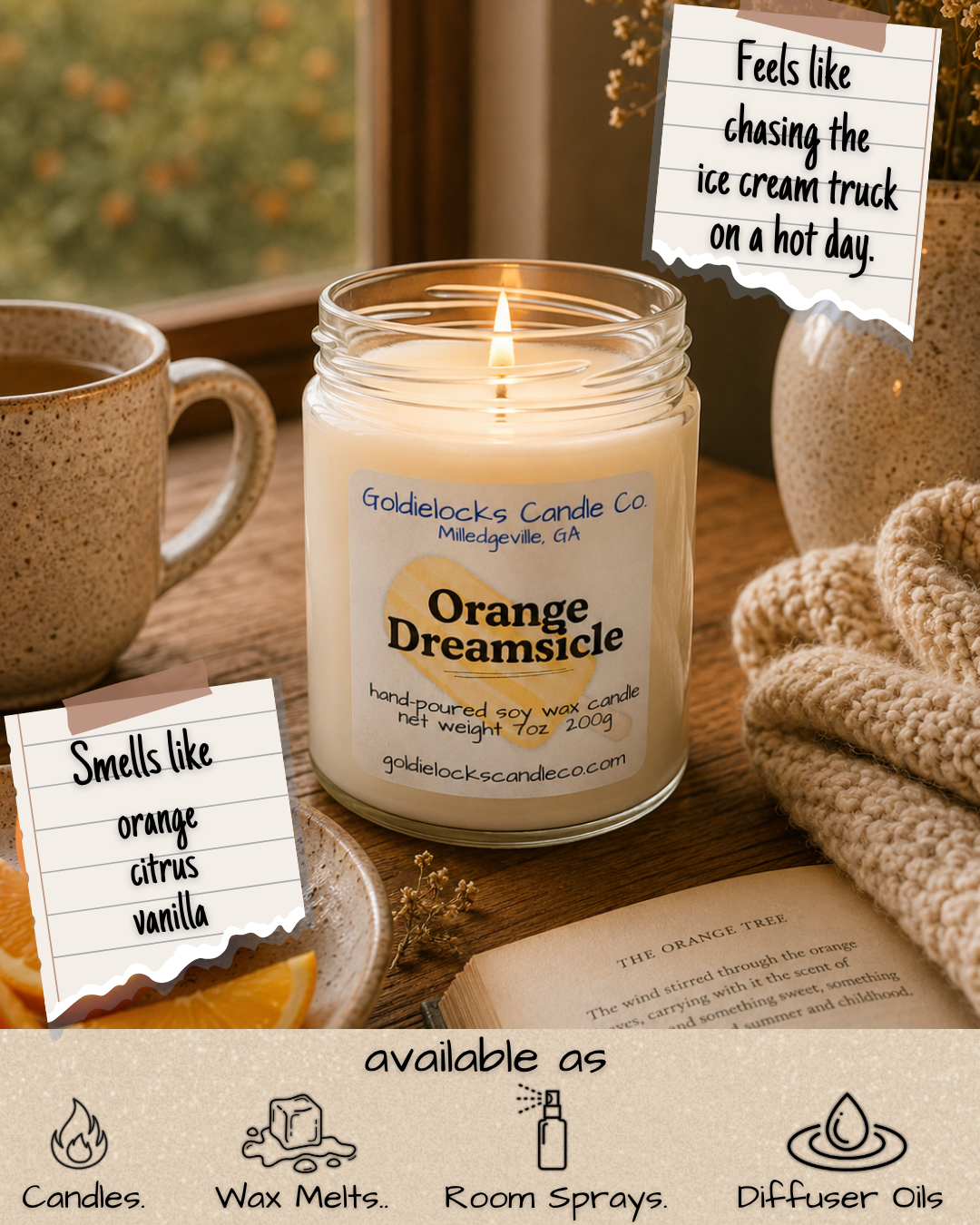 A lit soy wax candle labeled 'Orange Dreamsicle' on a wooden table next to a cup of tea, a cozy knitted blanket, an open book, and notes indicating it smells like orange, citrus, vanilla, and feels like chasing an ice cream truck on a hot day; the candle is available as candles, wax melts, room sprays, and diffuser oils.