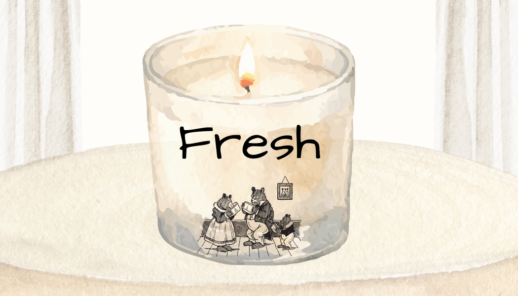 A white candle with a flame, labeled 'Fresh', decorated with a drawing of animals reading in a cozy room.