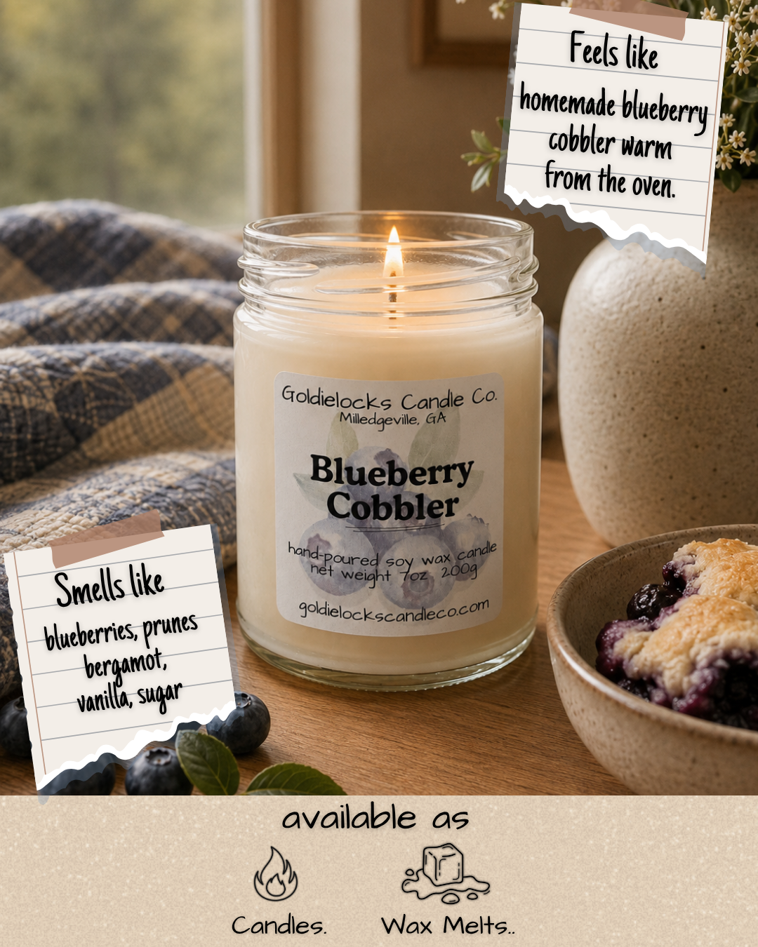 A lit blueberry cobbler scented candle from Goldielocks Candle Co. with notes of blueberries, prunes, bergamot, vanilla, and sugar, placed on a wooden table next to a bowl of blueberry cobbler and a plaid blanket, with notes describing the candle's scent and ingredients, and a label indicating it is available as candles and wax melts.