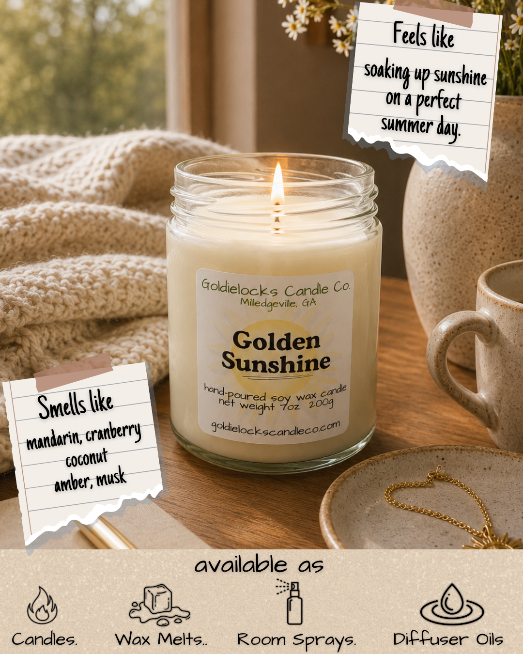 A lit white candle in a glass jar labeled "Golden Sunshine" on a wooden surface, surrounded by beige ceramics, a gold necklace on a plate, and a cozy knit blanket. Hanging notes mention the candle smells like mandarin, cranberry, coconut, amber, and musk, and feels like soaking up sunshine on a summer day. The image promotes candles, wax melts, room sprays, and diffuser oils.